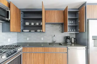 a kitchen with wooden cabinets and a sink at Blueground Clinton Hill rooftop nr Fort Greene Park NYC-1979 in Brooklyn