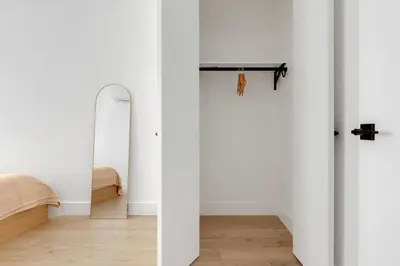 a white room with a mirror and a surfboard at Blueground Midtown East view nr UN Plaza NYC-2040 in New York