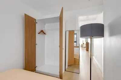 a bedroom with a mirror and a lamp at Blueground Midtown East view nr UN Plaza NYC-2040 in New York