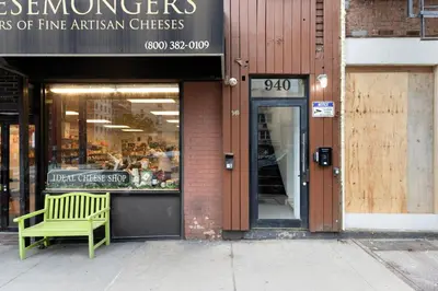 a green bench sitting outside of a store at Blueground Midtown East view nr UN Plaza NYC-2040 in New York
