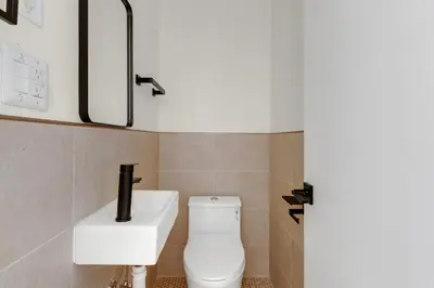 a bathroom with a toilet and a sink at Blueground Midtown East view nr UN Plaza NYC-2040 in New York
