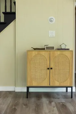 a wooden cabinet with two baskets in a room at Cozy Cottage in Glen Spey in Glen Spey