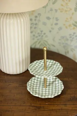 a plate with a gold needle on a table at Cozy Cottage in Glen Spey in Glen Spey