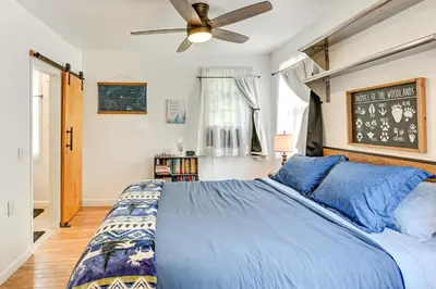 a bedroom with a blue bed and a ceiling fan at Ice Fish, Snowshoe and Ski Group Getaway in Summit in Summit