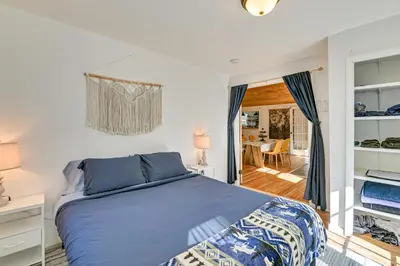 a bedroom with a blue bed and a dining room at Ice Fish, Snowshoe and Ski Group Getaway in Summit in Summit