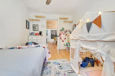 a bedroom with two beds and a crib at Ice Fish, Snowshoe and Ski Group Getaway in Summit in Summit