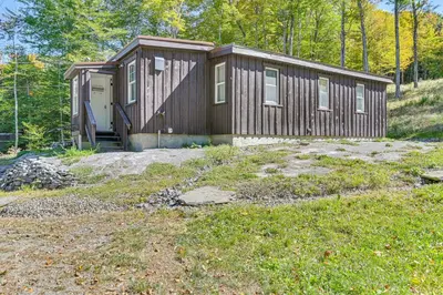 a small cabin in the middle of a yard at Ice Fish, Snowshoe and Ski Group Getaway in Summit in Summit