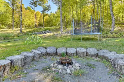 a fire pit in a yard with a playground at Ice Fish, Snowshoe and Ski Group Getaway in Summit in Summit
