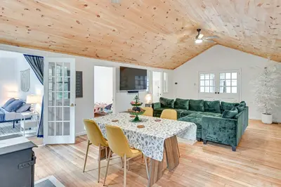 a living room with a green couch and a table at Ice Fish, Snowshoe and Ski Group Getaway in Summit in Summit
