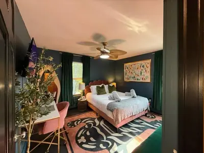 a bedroom with a bed and a ceiling fan at Chic Hudson Escape Pet Friendly Hot Tub in Hudson