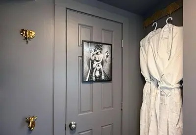 a bathroom with a door with a picture on the wall at Chic Hudson Escape Pet Friendly Hot Tub in Hudson