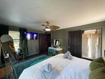 a bedroom with a large bed with towels on it at Chic Hudson Escape Pet Friendly Hot Tub in Hudson