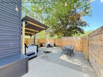 a patio with a grill and a table and chairs at Chic Hudson Escape Pet Friendly Hot Tub in Hudson