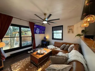 a living room with a couch and a ceiling fan at Chic Hudson Escape Pet Friendly Hot Tub in Hudson