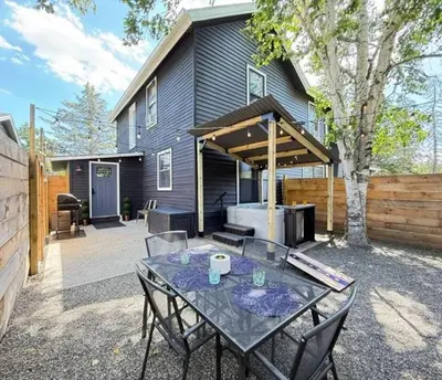 a patio with a table and chairs in front of a house at Chic Hudson Escape Pet Friendly Hot Tub in Hudson