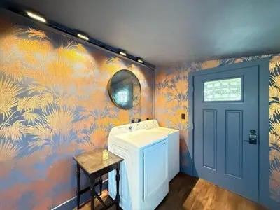 a washing machine in a laundry room with a colorful wall at Chic Hudson Escape Pet Friendly Hot Tub in Hudson