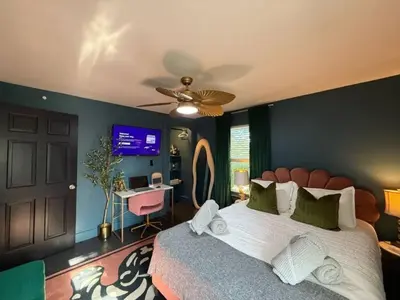 a bedroom with a bed and a ceiling fan at Chic Hudson Escape Pet Friendly Hot Tub in Hudson
