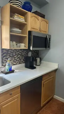 a kitchen with a sink and a microwave at Modern Comfort 1BR in Jersey City in Jersey City