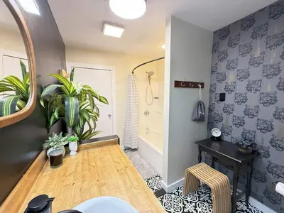 a bathroom with a table and a mirror and plants at Vibing Hudson Retreat Pet-Friendly w Hot Tub in Hudson