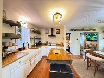 a kitchen with white cabinets and a wooden counter top at Vibing Hudson Retreat Pet-Friendly w Hot Tub in Hudson