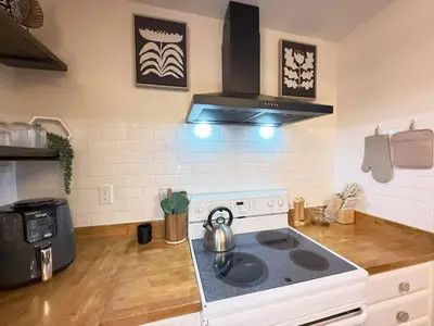 a kitchen with a stove with a tea kettle on it at Vibing Hudson Retreat Pet-Friendly w Hot Tub in Hudson