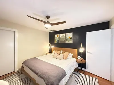 a bedroom with a bed and a ceiling fan at Vibing Hudson Retreat Pet-Friendly w Hot Tub in Hudson