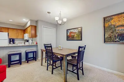 a kitchen and dining room with a table and chairs at Deer Creek 8A in Dover