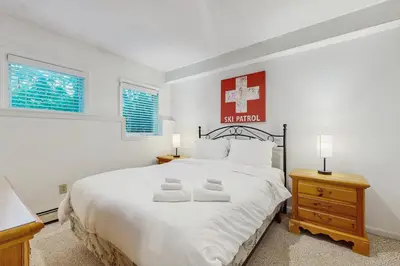a bedroom with a large white bed with two towels on it at Deer Creek 8A in Dover