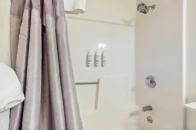 a bathroom with a shower curtain and a tub at Deer Creek 8A in Dover
