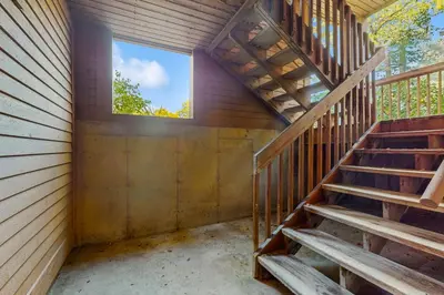 an empty room with stairs and a window at Deer Creek 8A in Dover