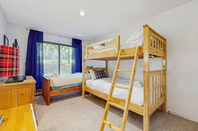 a bedroom with two bunk beds and a desk at Deer Creek 8A in Dover