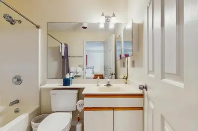 a bathroom with a sink and a toilet and a mirror at Deer Creek 8A in Dover