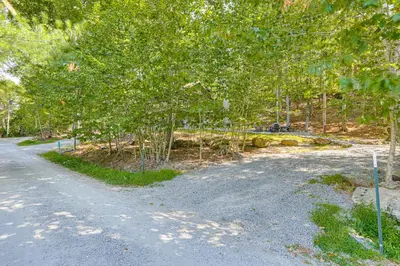a dirt road with trees on the side of it at Less Than 1 Mi to Lake Cabin with Hot Tub in Greentown! in Greentown