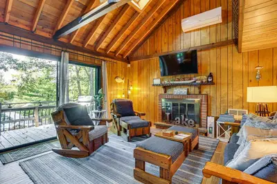 a living room with a couch and a fireplace at Less Than 1 Mi to Lake Cabin with Hot Tub in Greentown! in Greentown