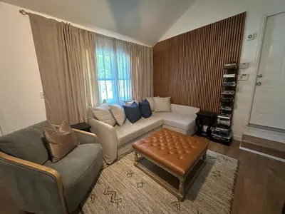 a living room with a couch and a table at 5 Min walk to Stony Brook University in Stony Brook
