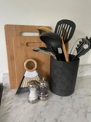a black container of utensils sitting on a counter at 5 Min walk to Stony Brook University in Stony Brook