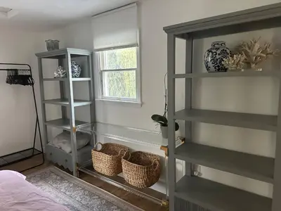 a room with shelves and a window and a bed at 5 Min walk to Stony Brook University in Stony Brook