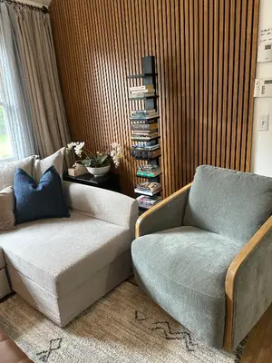 a living room with a couch and a chair at 5 Min walk to Stony Brook University in Stony Brook