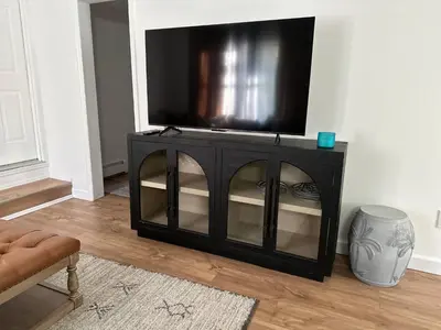 a black entertainment center with a flat screen tv on it at 5 Min walk to Stony Brook University in Stony Brook
