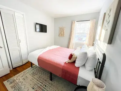 a bedroom with a bed with a teddy bear on it at Sparkling Saratoga 3BR home near Track and SPAC Dogs in Saratoga Springs