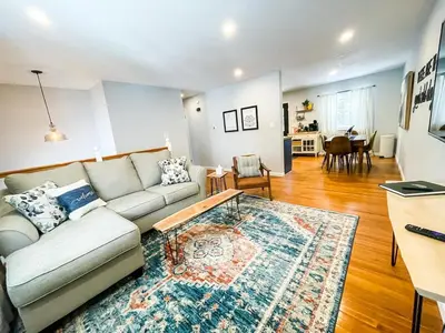 a living room with a couch and a table at Sparkling Saratoga 3BR home near Track and SPAC Dogs in Saratoga Springs