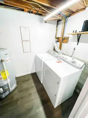a kitchen with white appliances and a refrigerator at Sparkling Saratoga 3BR home near Track and SPAC Dogs in Saratoga Springs