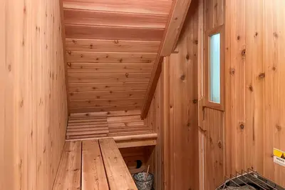 a wooden sauna with a wooden bench in it at Cozy Log Cabin Near Mt Snow Views, Modern Comfort in Wilmington