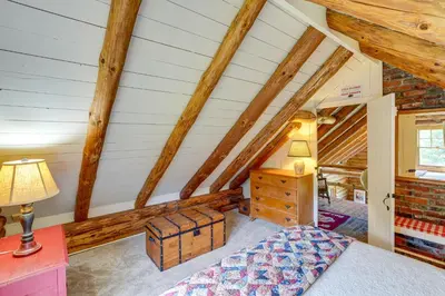 a bedroom with a bed and a wooden attic at Cozy Log Cabin Near Mt Snow Views, Modern Comfort in Wilmington