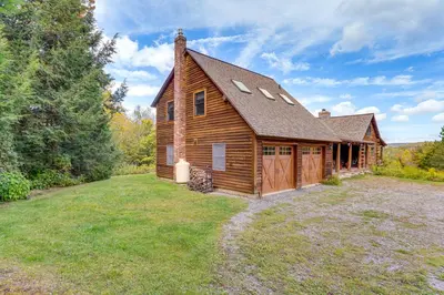 a log cabin with a large yard in front of it at Cozy Log Cabin Near Mt Snow Views, Modern Comfort in Wilmington