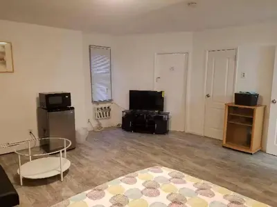 an empty living room with a television and a table at Roslyn Room 1 Private Bathroom in Roslyn
