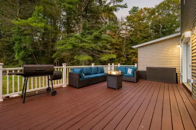 a deck with a grill and a couch and a barbecue at Family Oasis Pool Firepit Creek Near Delaware in Sparrow Bush