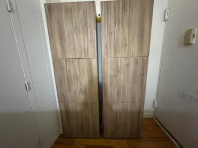 a room with a large wooden closet in a room at West Village Apartment Rent 30 days or more in New York