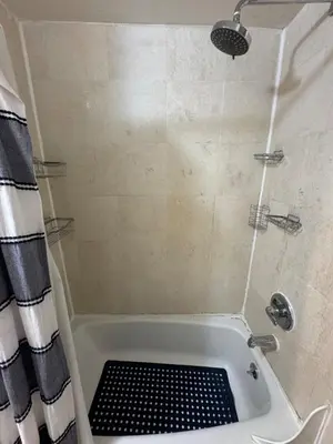 a bathroom with a shower with a bath tub at West Village Apartment Rent 30 days or more in New York