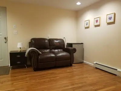 a brown leather chair in a living room at Cozy1B1B W Private Entrance in Jericho
